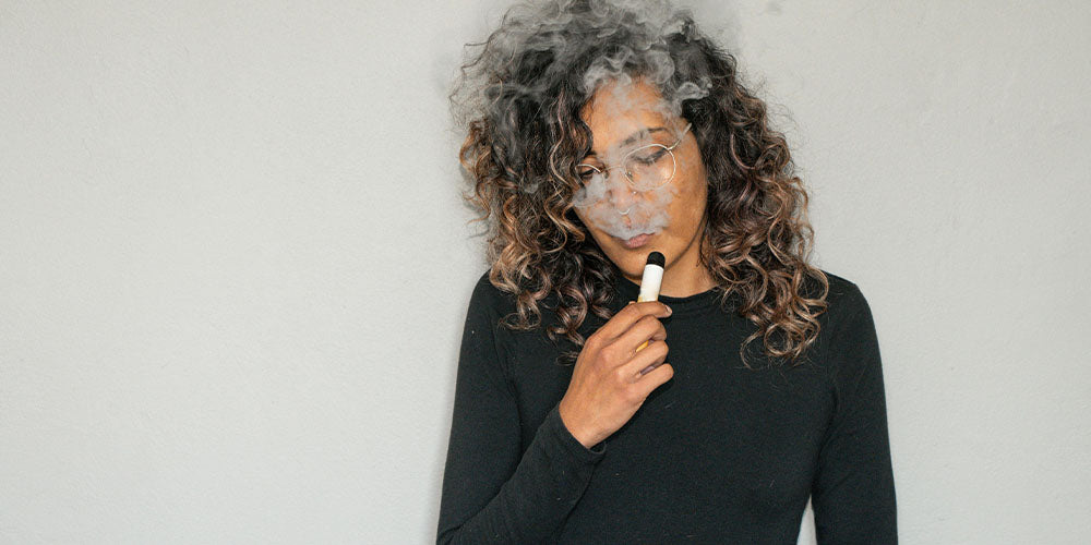 woman vaping disposable vape
